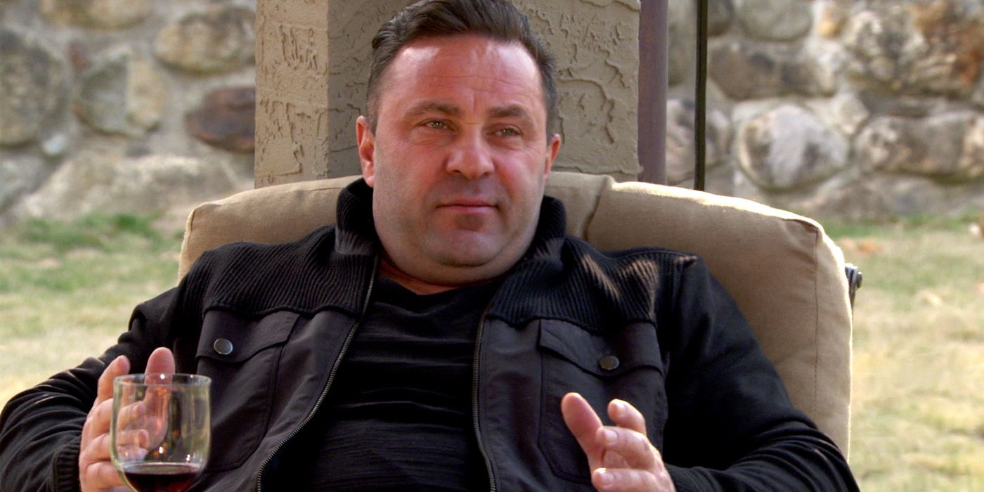 Joe Giudice in The Real Housewives of New Jersey sitting on chair with wine