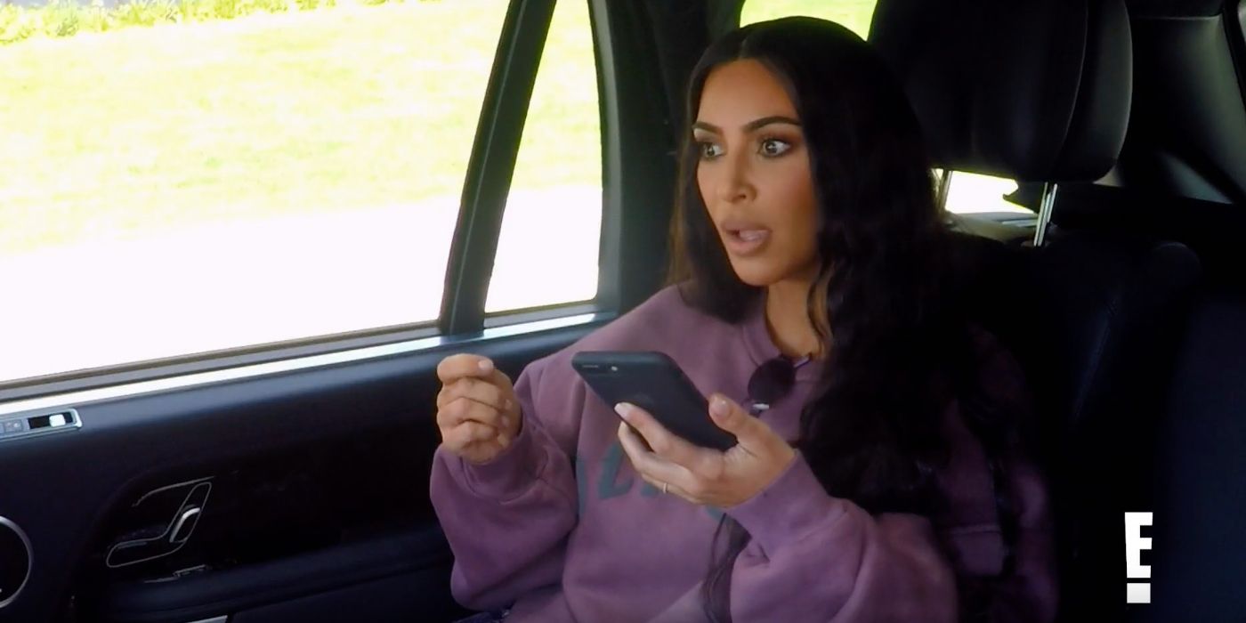 Kim Kardashian West sitting in a car talking into her phone's speaker on Keeping Up with the Kardashians