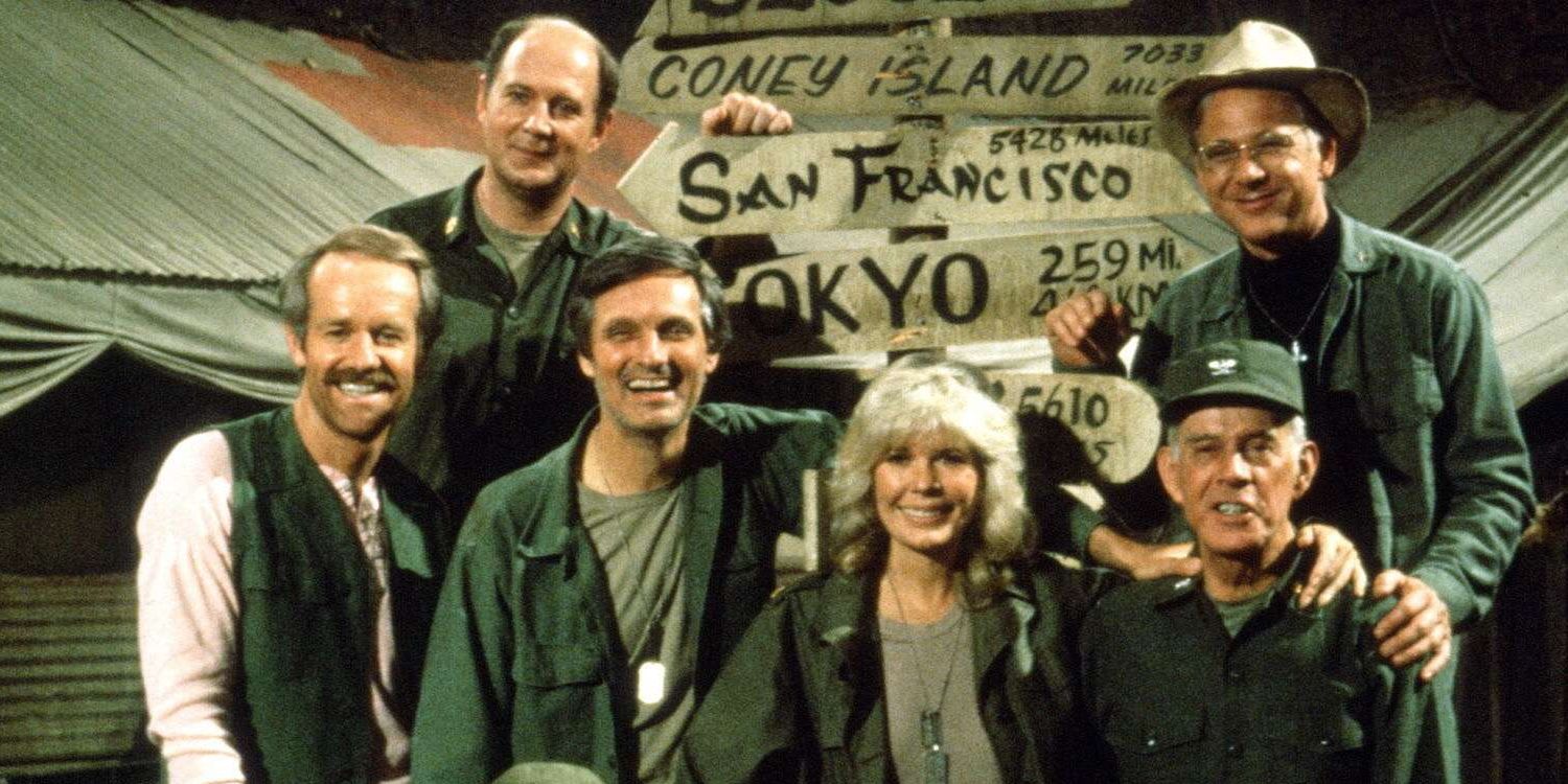 MASH Cast smiling and looking at the camera for the show