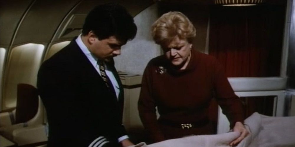 Jessica examines a body on a plane in Murder, She Wrote
