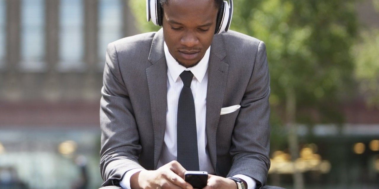 Man listening to content on a smartphone