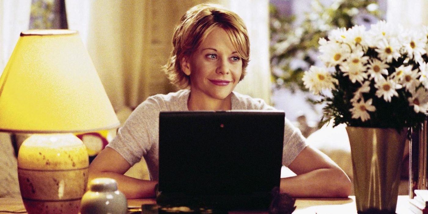 Kathleen using her computer and smiling in You've Got Mail
