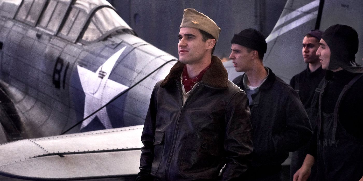 Four soldiers standing in front of a plane in Midway.