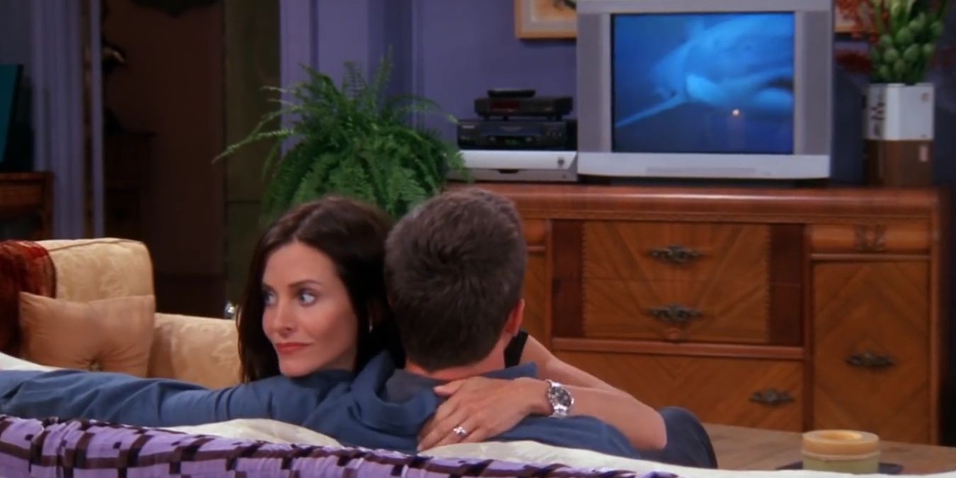 Monica hugging Chandler with sharks on 