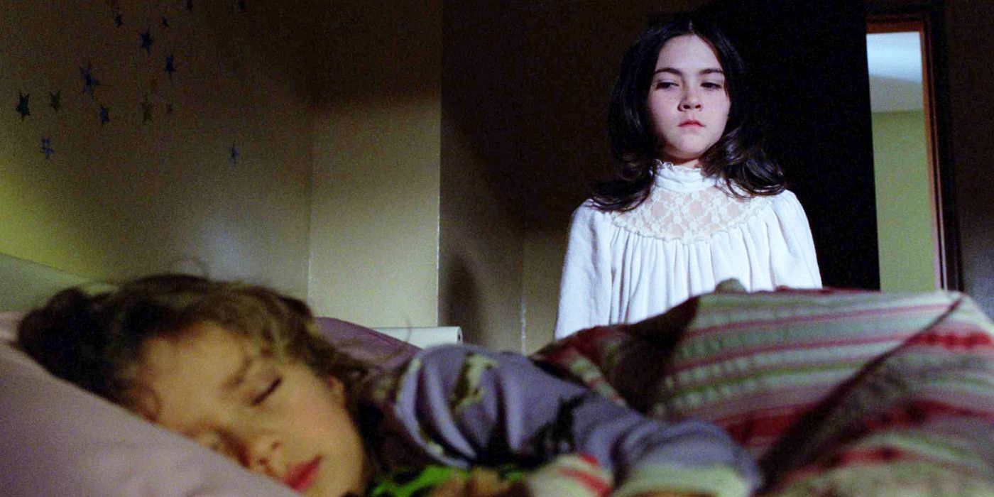 Esther looking at a sleeping girl in Orphan.