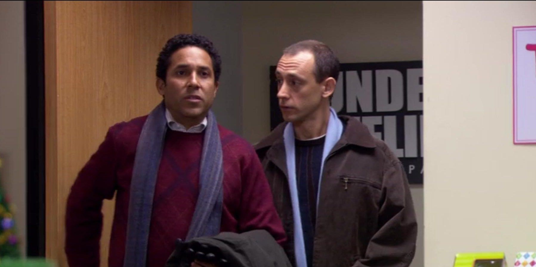 Oscar and Gil standing next to each other in The Office