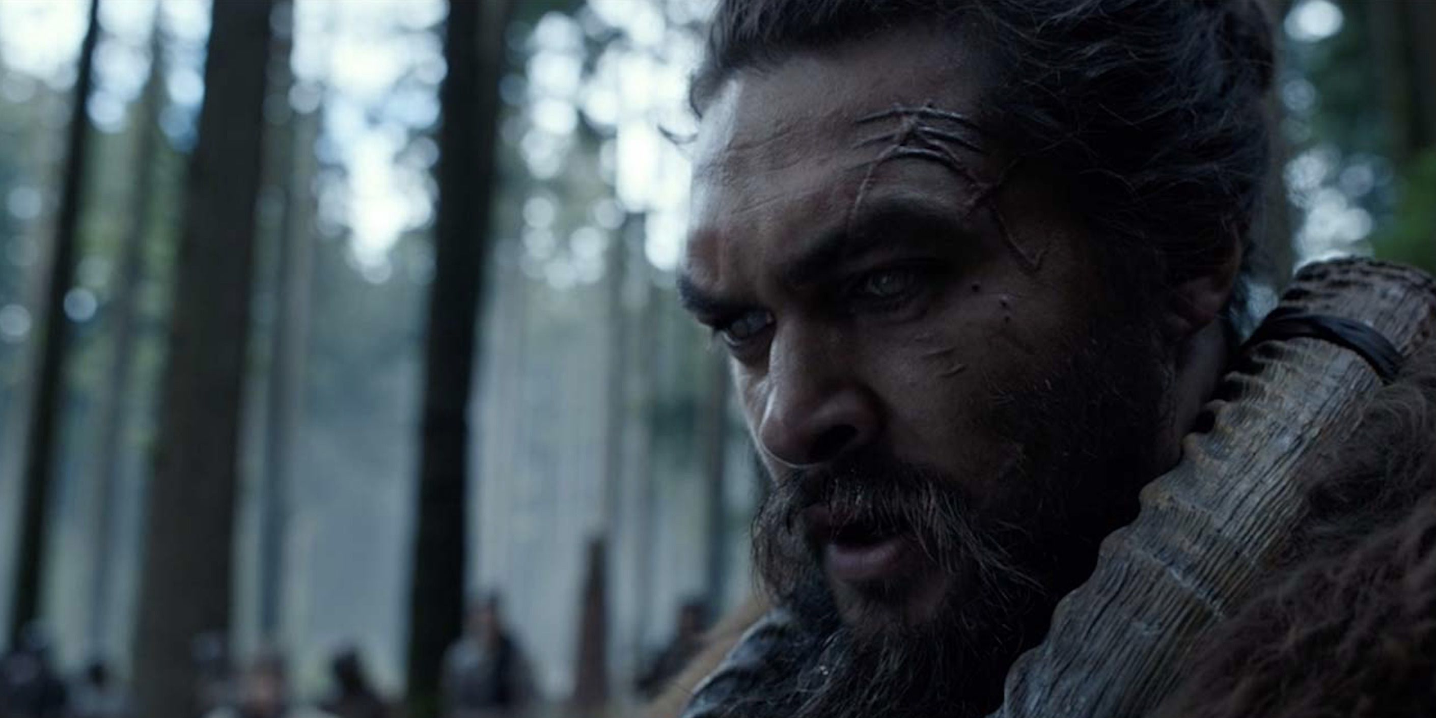 Jason Momoa looking angry in the woods in See