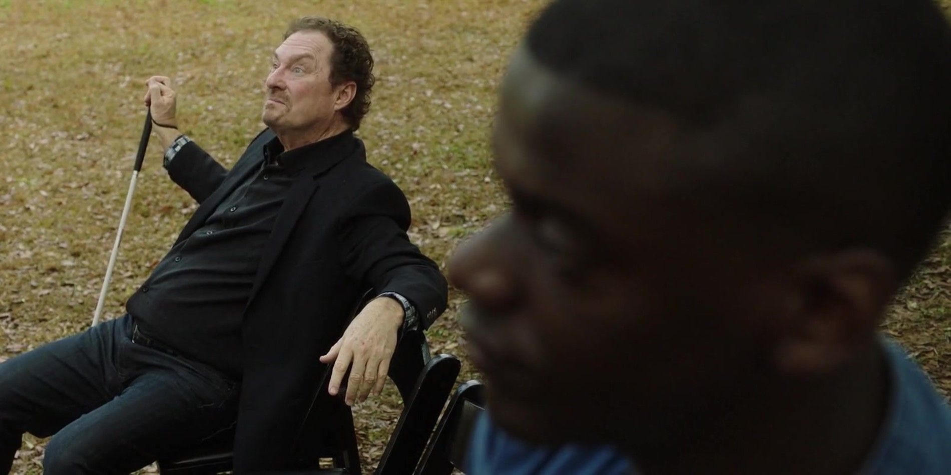Stephen Root sits in a wheelchair next to Daniel Kaluuya in Get Out