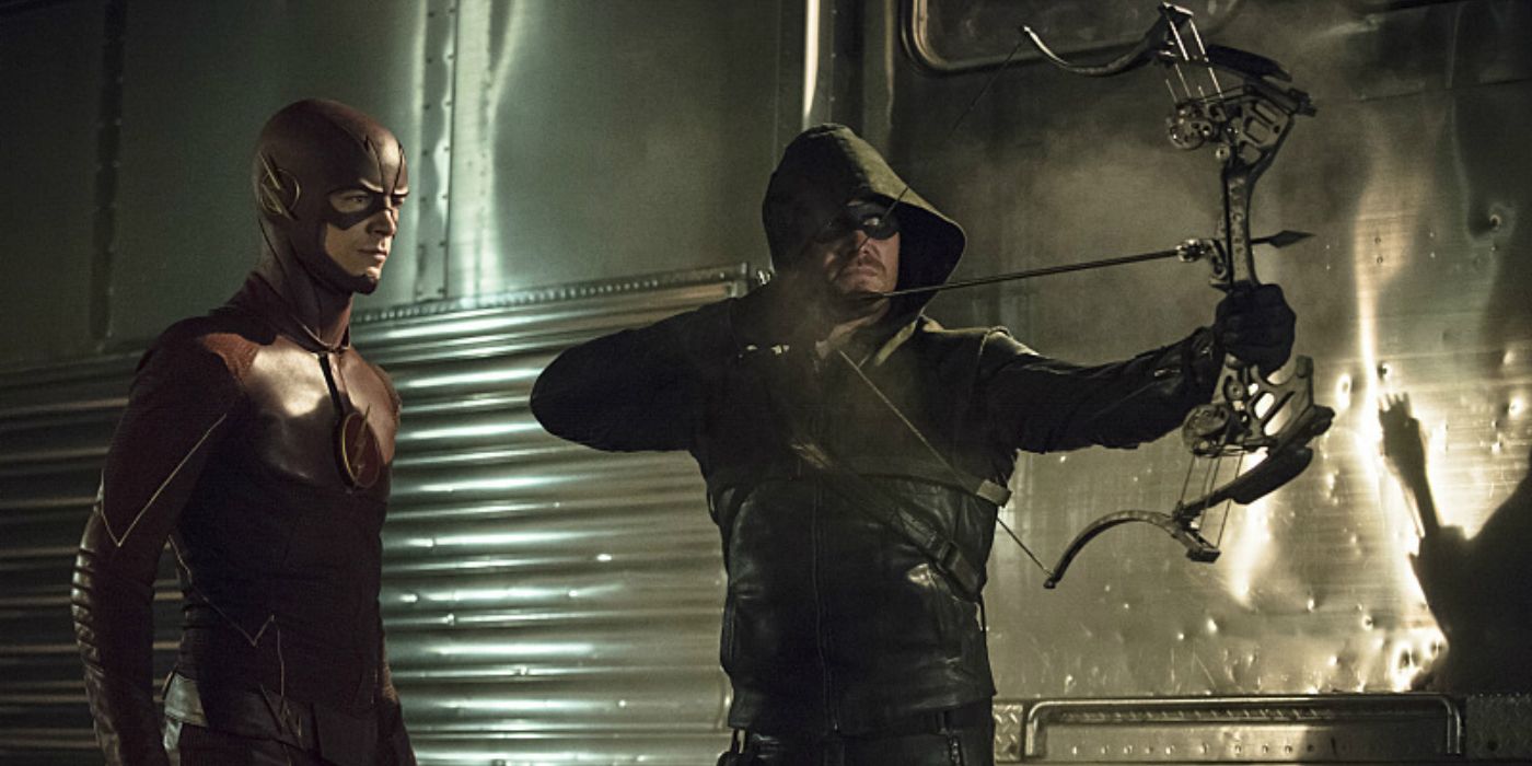 Green Arrow shoots an arrow as Flash looks on