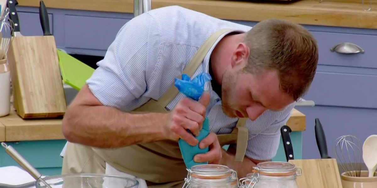 One of the contestants carefully piping a cake on The Great British Bake Off.
