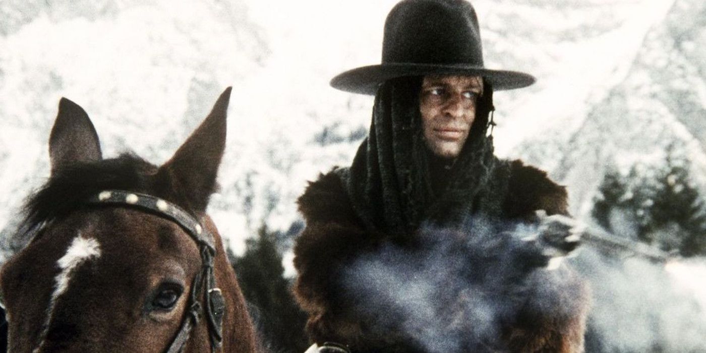 A male character rides a horse through a snowy field in The Great Silence