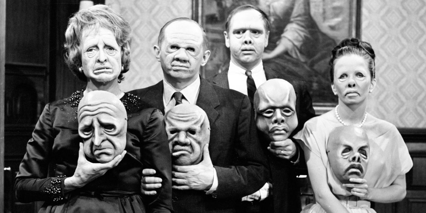 A still from the Twilight Zone episode &quot;The Masks&quot; of the characters holding their masks with their faces distorted