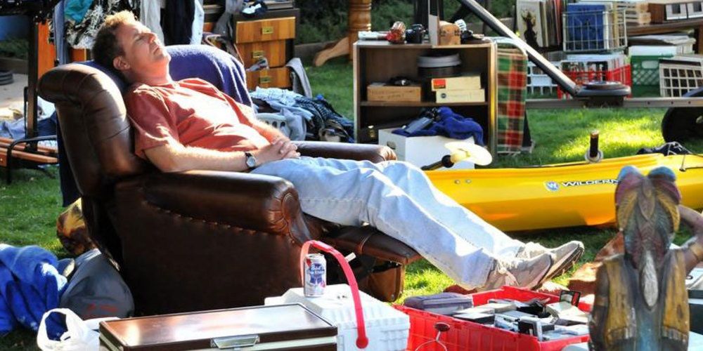 Will Ferrell laying down on a sofa outside in Everything Must Go