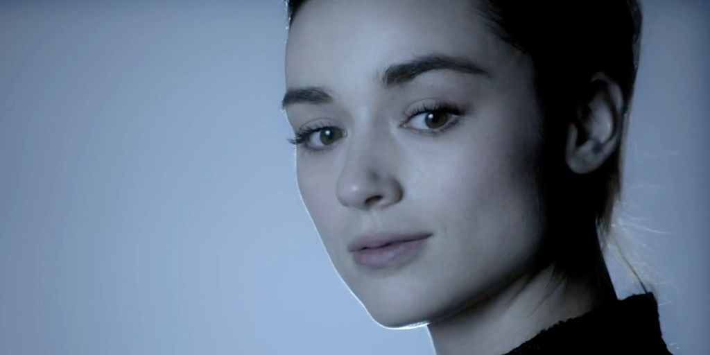 Allison Argent smiling at something in Teen Wolf.