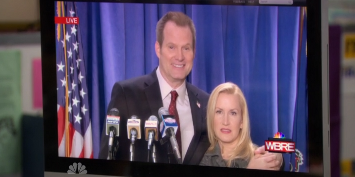 Robert smiling and Angela frowning at a press conference on The Office