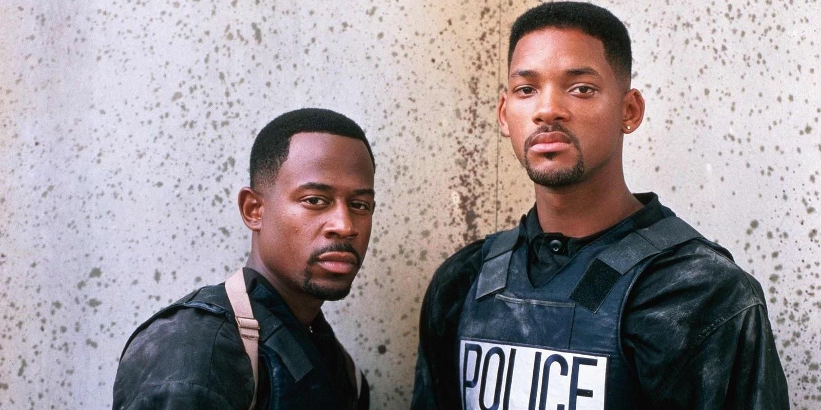 Martin Lawrence and Will Smith standing in front of a white and gray wall in Bad Boys