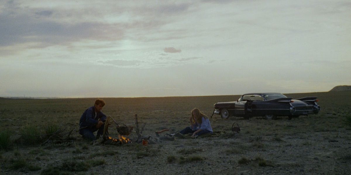 Two characters doing a bonfire on an open field in Badlands.