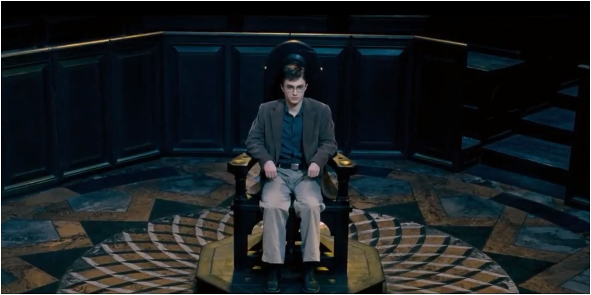 Harry sitting down for his trial 