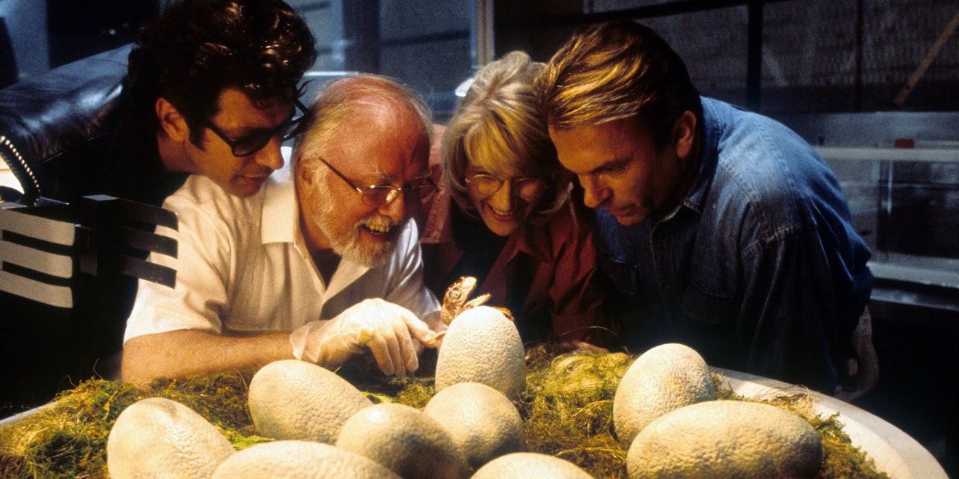 Ian Malcolm, John Hammond, Ellie Sattler, and Alan Grant looking at a dinosaur egg in Jurassic Park
