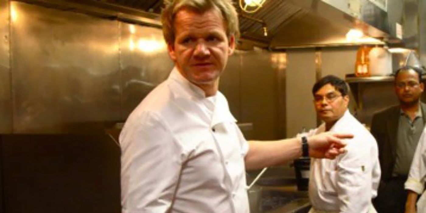 Gordon Ramsay in the back kitchen, pointing at something, a cook in the background.