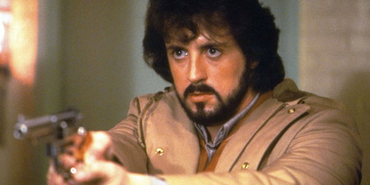 Sylvester Stallone points a gun off-camera in Nighthawks.