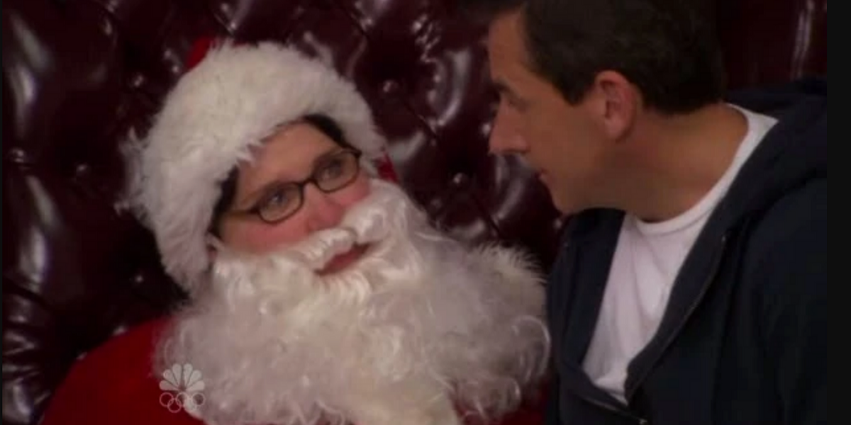 Phyllis Vance as Santa with Michael on her lap in The Office