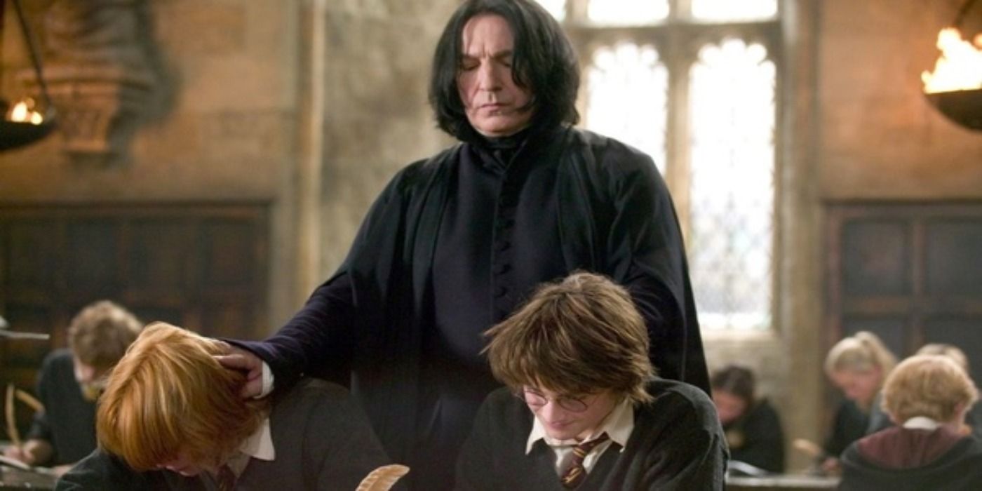 Snape forces Ron and Harry's heads down