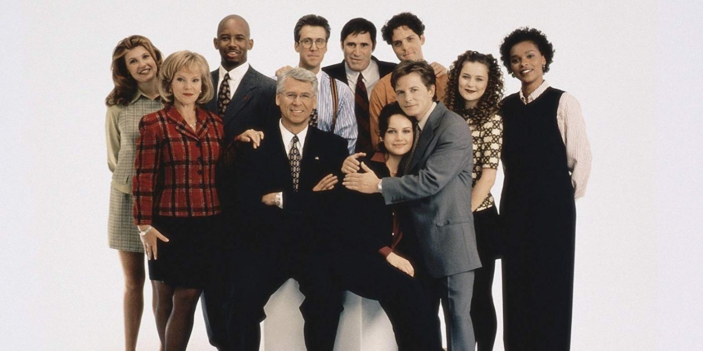 The cast of Spin City standing together and smilling 