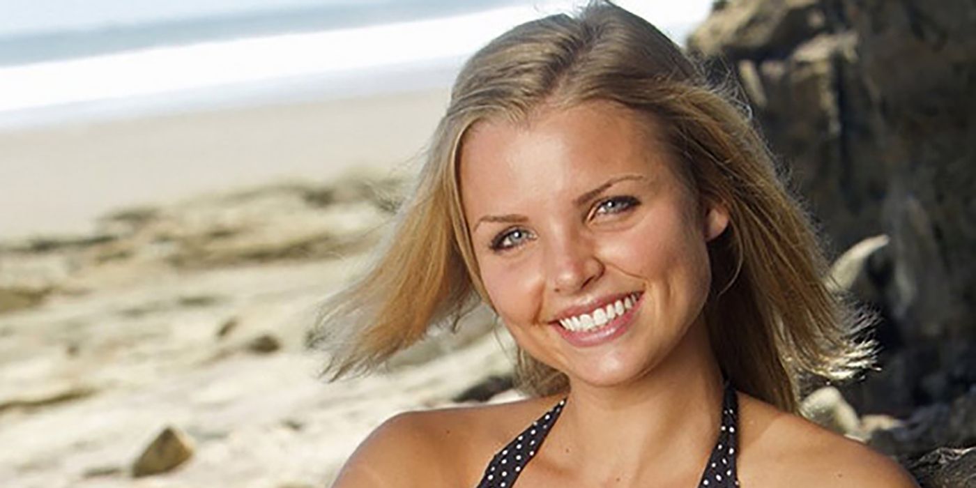 Andrea Boehlke on a beach smiling for the camera in Survivor