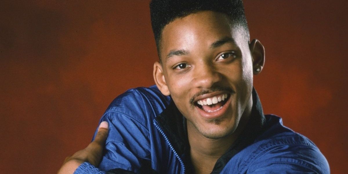 Will Smith smiling while wearing a blue tracksuit in The Fresh Prince of Bel-Air