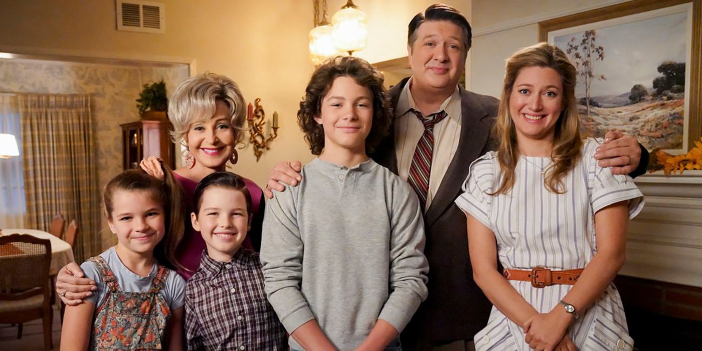 The Cooper family posing for a photo in a scene from Young Sheldon.