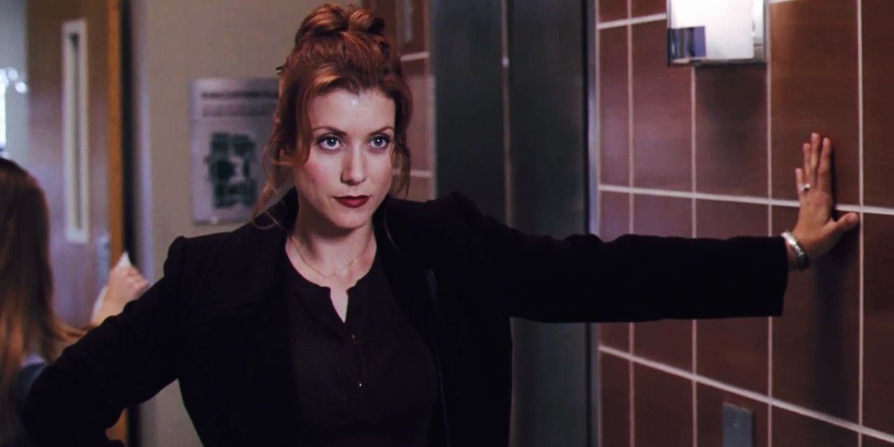 Addison leaning against a wall in Grey's Anatomy