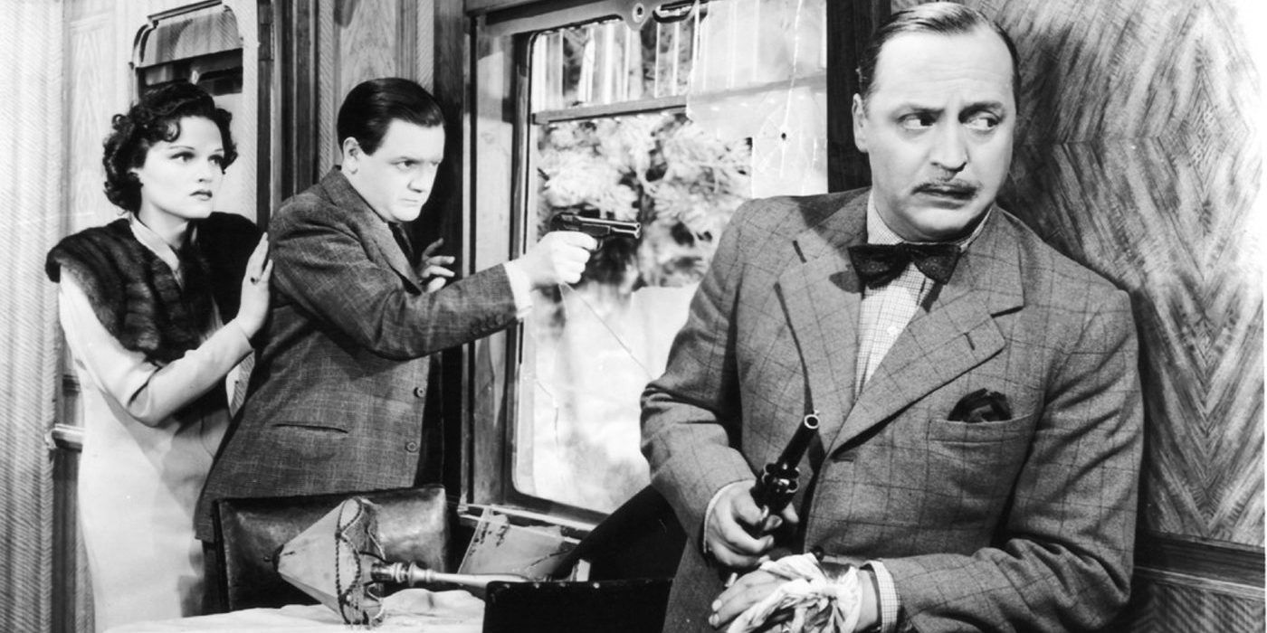 Train passengers look out window while brandishing gun in The Lady Vanishes