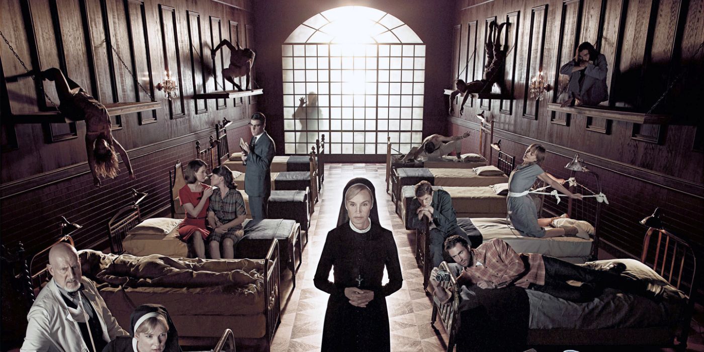 The cast of American Horror Story Asylum in one room with many beds