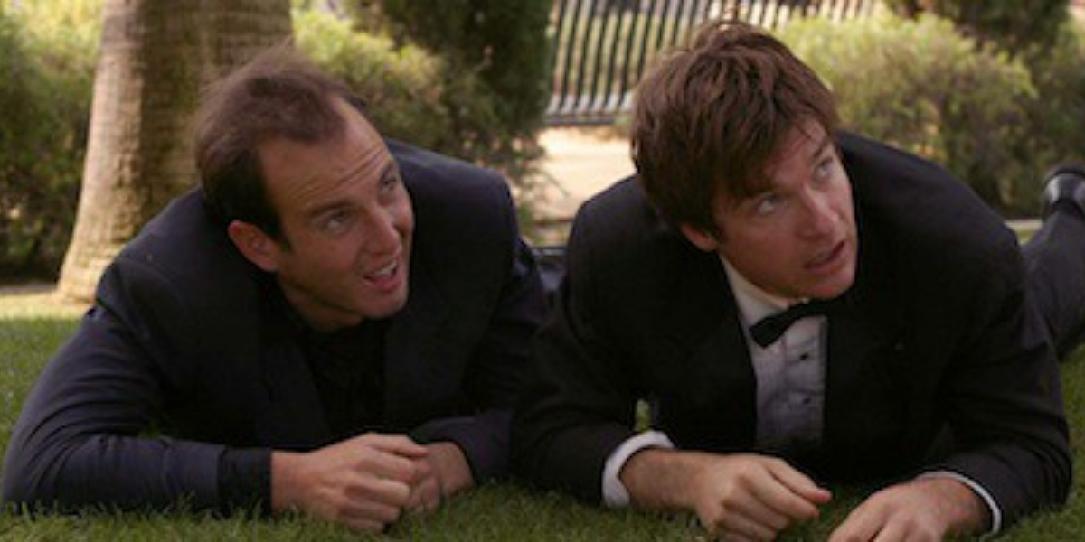 Gob and Michael crawl on the grass