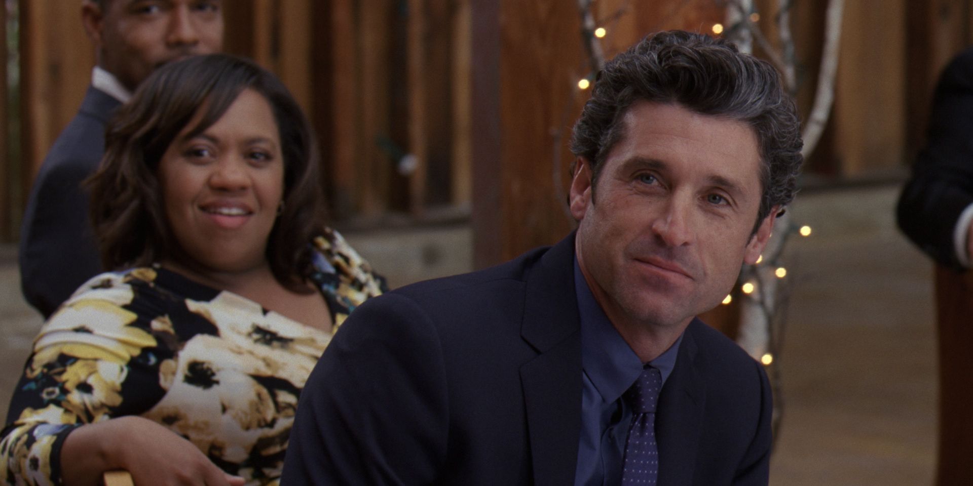 Bailey and Derek sitting together and smiling on Grey's Anatomy