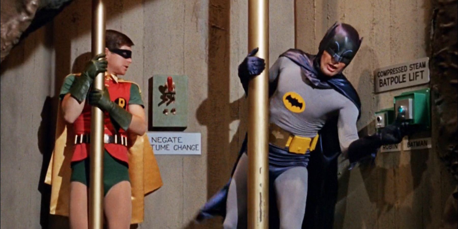 Batman and Robin slide down poles