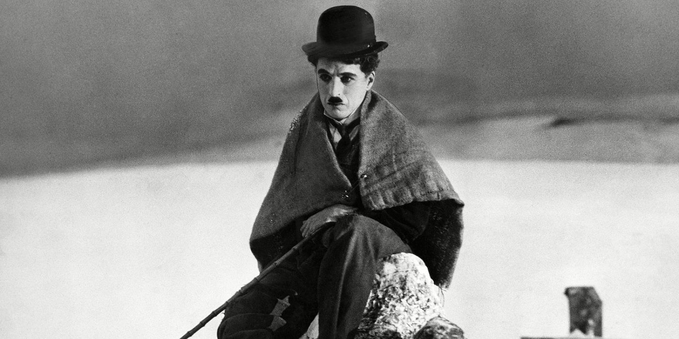 Charlie Chaplin sitting on a rock