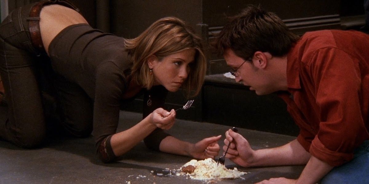 Chandler and Rachel eating cheesecake on the floor in Friends