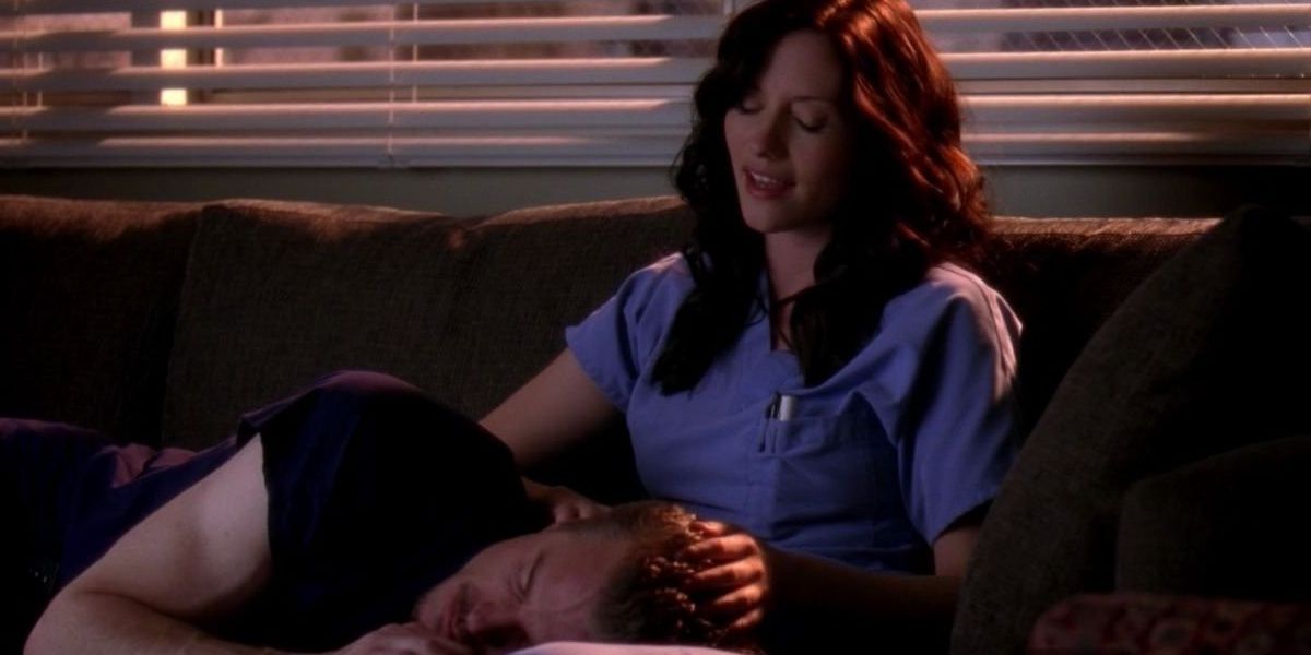 Mark resting his head on Lexie's lap on the couch in Grey's Anatomy 