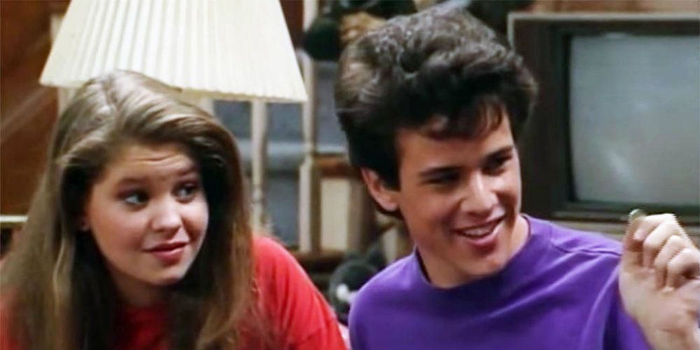 DJ Tanner and Steve Hale sit on the couch in the Tanner family living room and smile