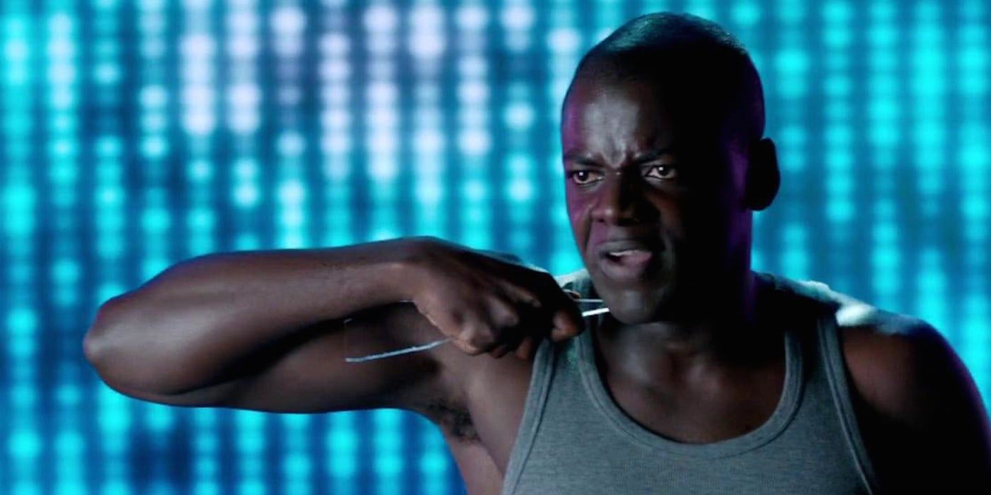 Daniel Kaluuya as Bing holding a shard of glass to his neck in Black Mirror.