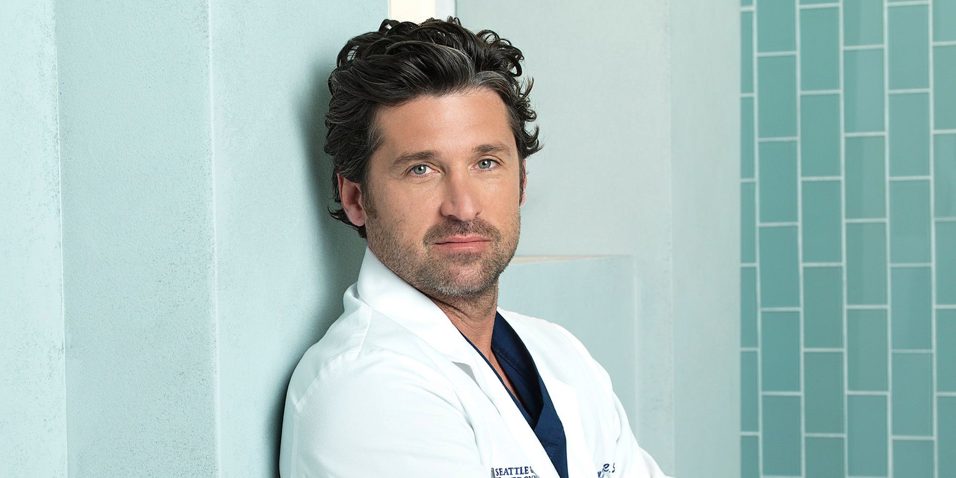 Derek leaning against a wall on Grey's Anatomy