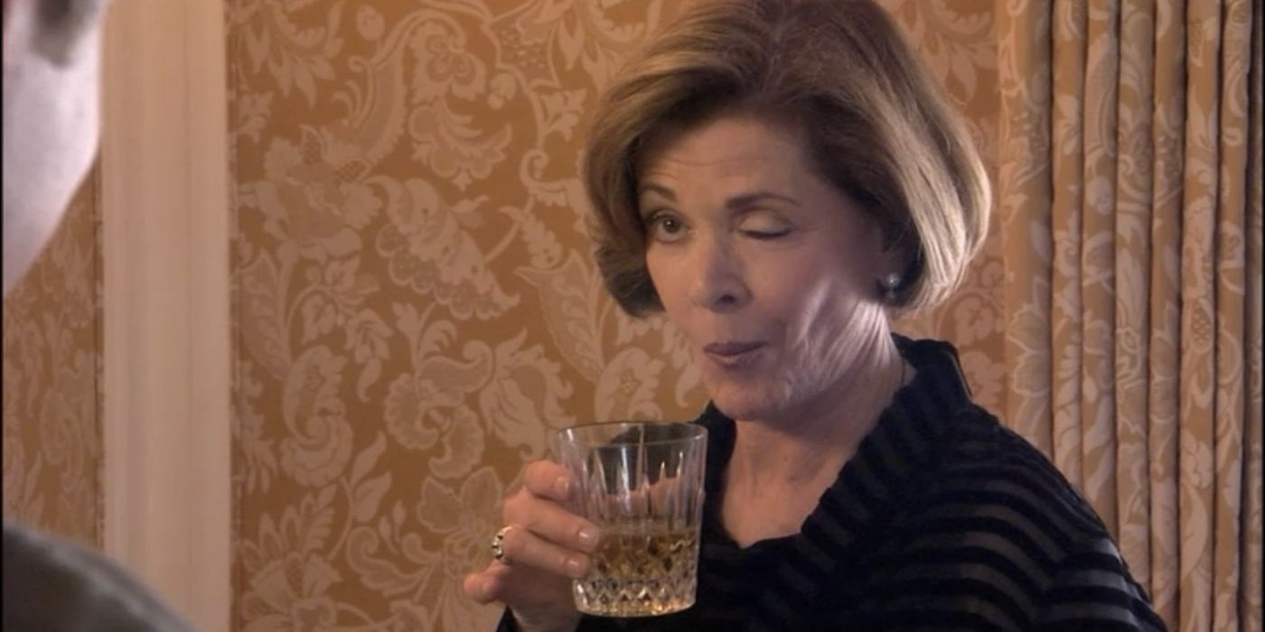 Lucille Bluth winking and drinking