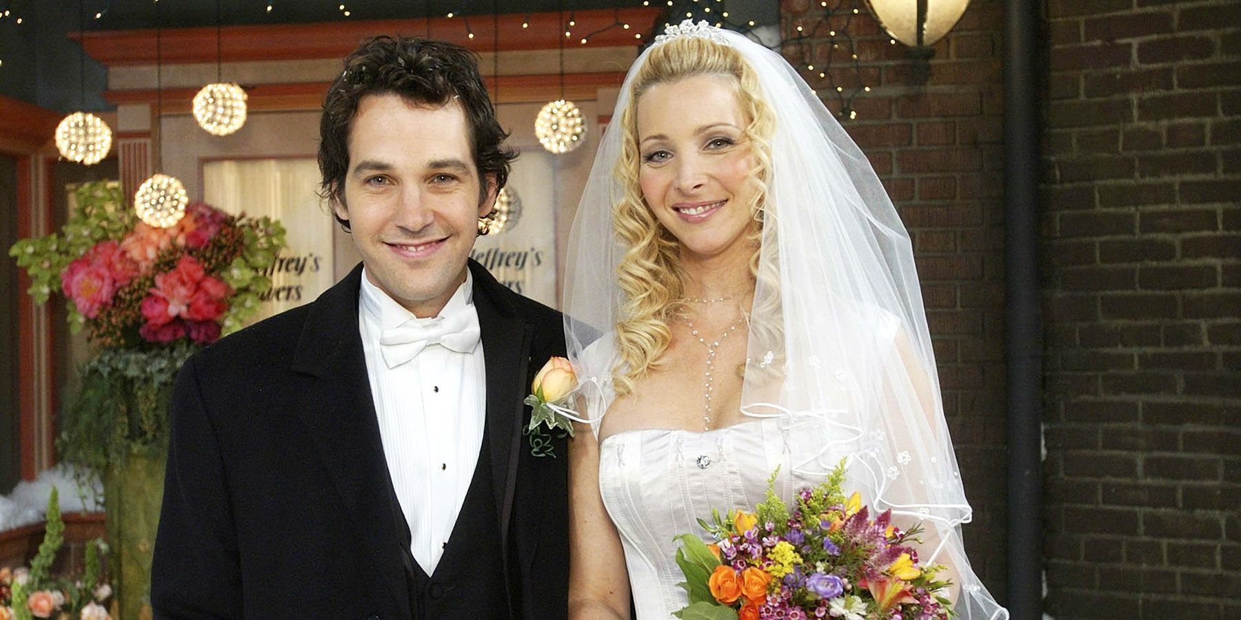 Phoebe and Mike smiling at their wedding in Friends