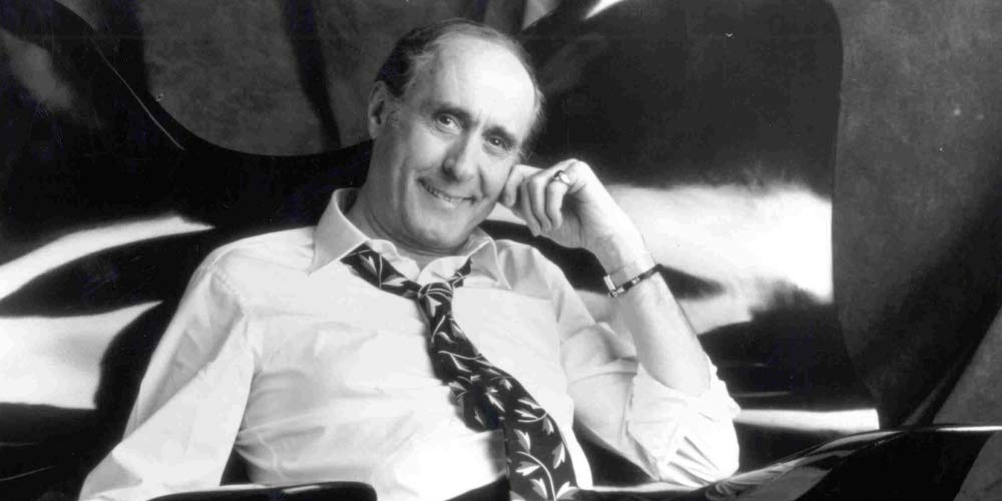 Henry Mancini sitting down and resting his head on his hand