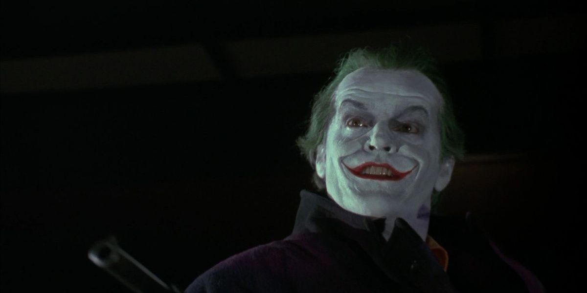 Jack Nicholson's Joker holding out a pistol in Batman (1989)