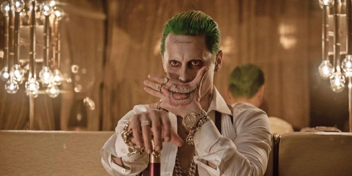 Joker holds his hand to his mouth in Suicide Squad.