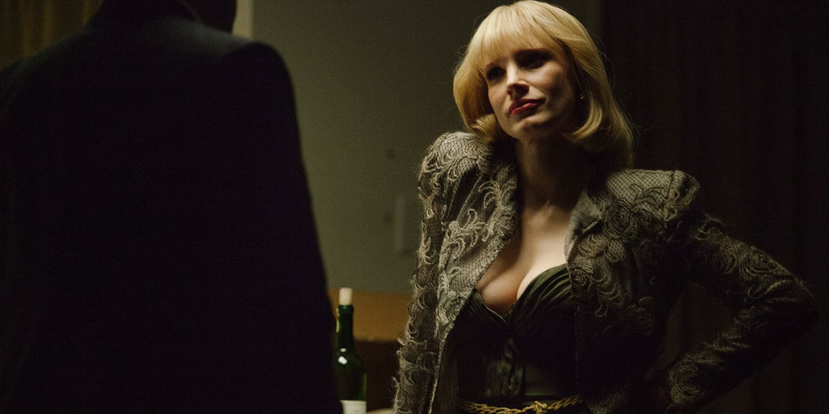 Anna with her hand on her waist in A Most Violent Year