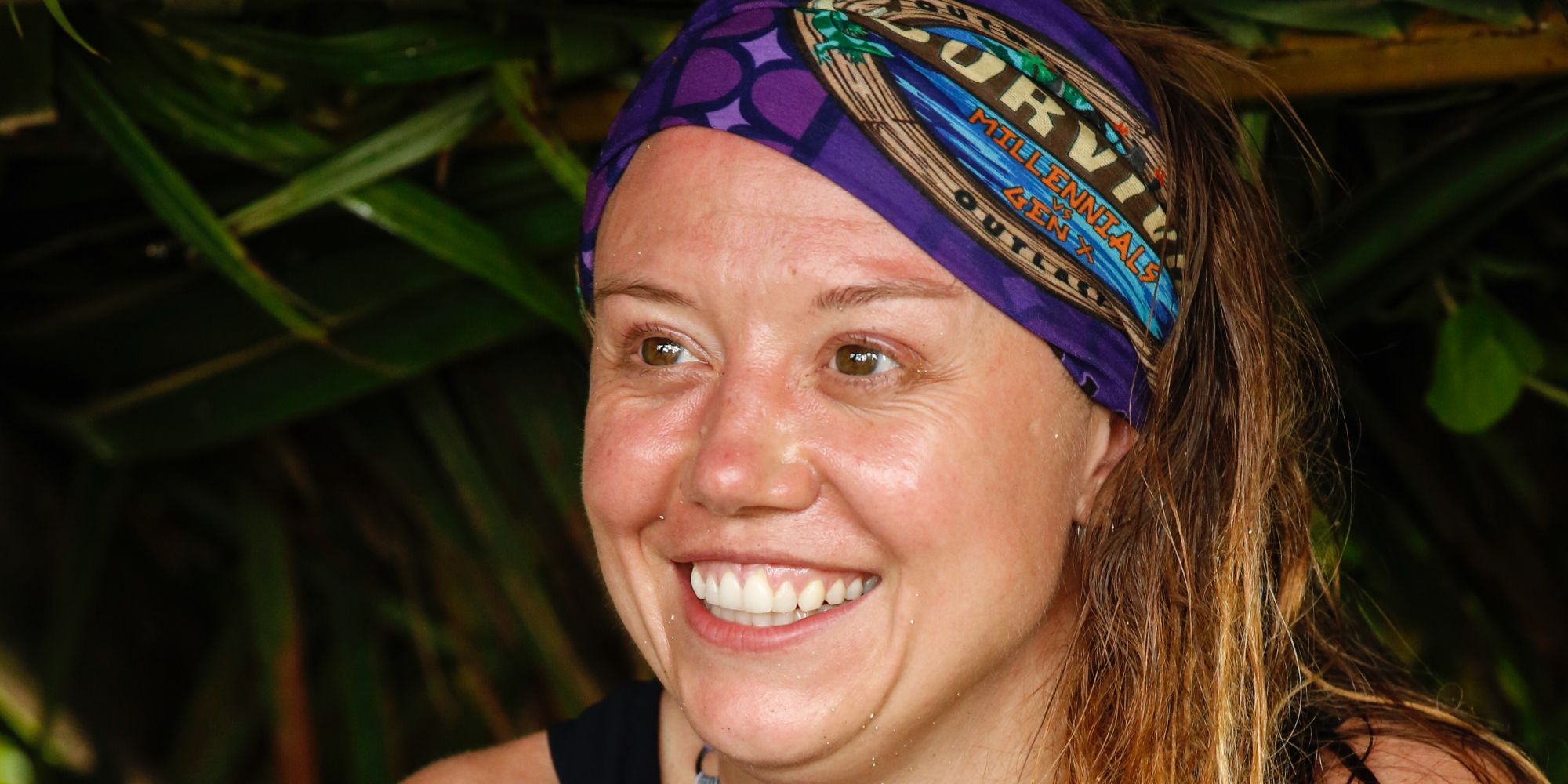 Jessica Lewis smiling while looking to the distance in Survivor.